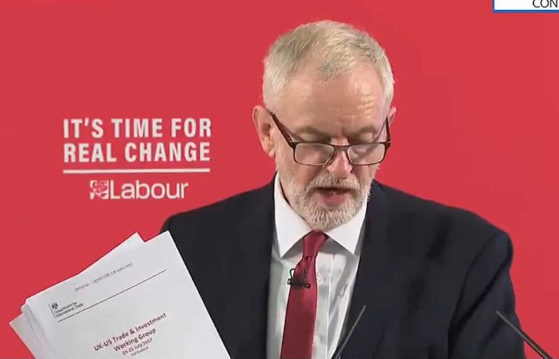 Jeremy Corbyn shows an unredacted copy of a US trade deal document.